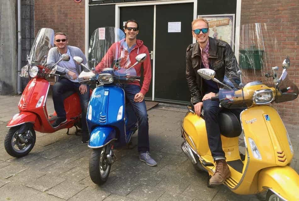 Vespa primavera in red and two Vespa Sprint in blue and yellow