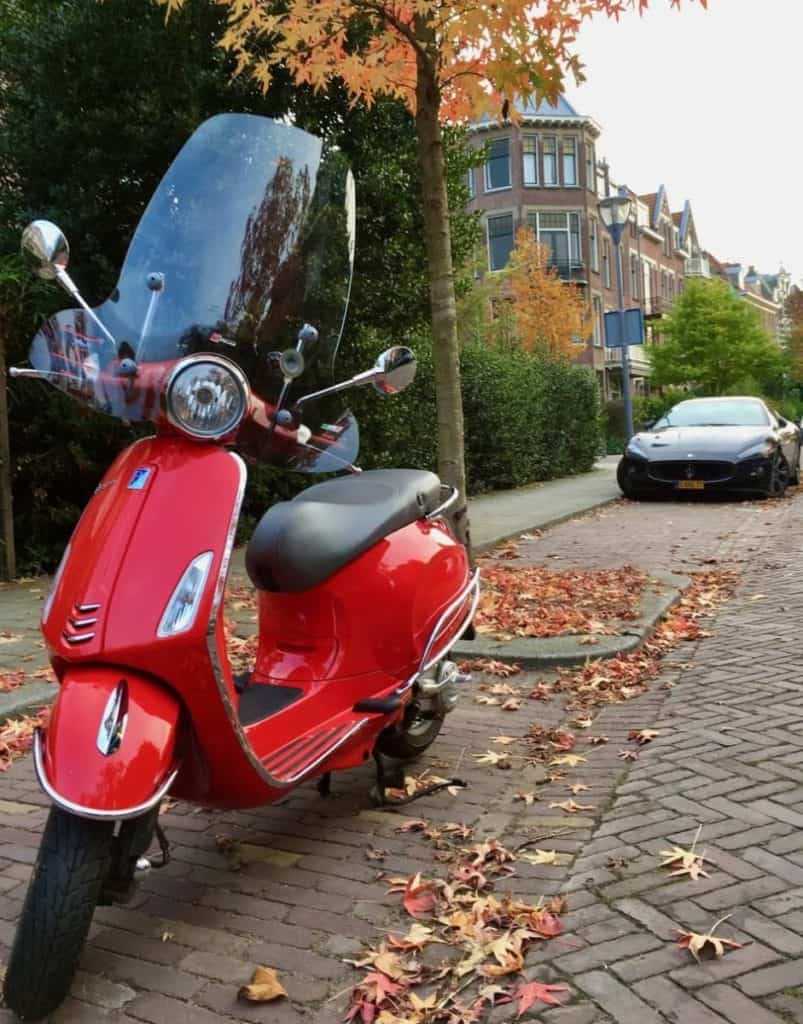 Red Vespa Primavera more eco friendly than the Maserati