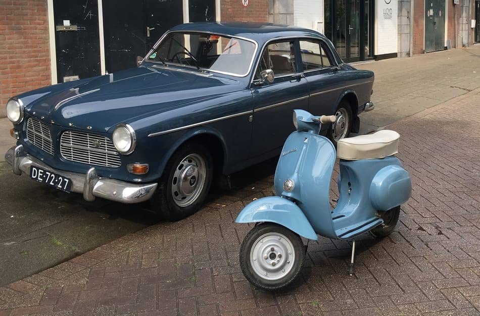 a classic car and vespa