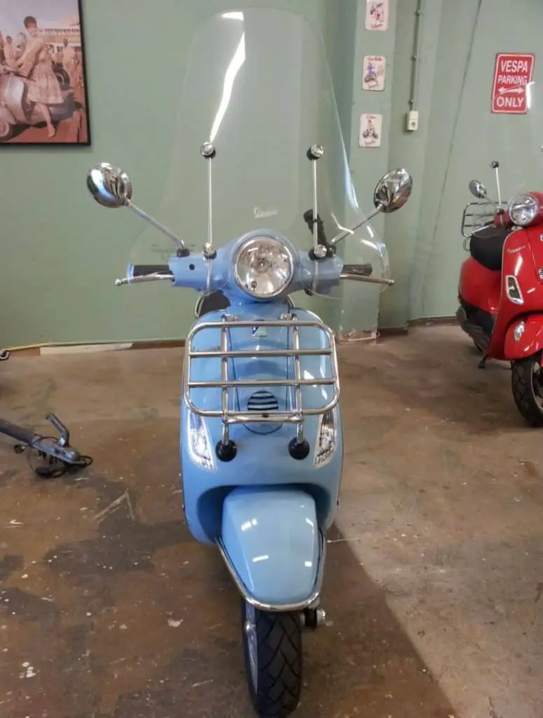 good looking Vespa LX in baby blue but with run down and modified engine