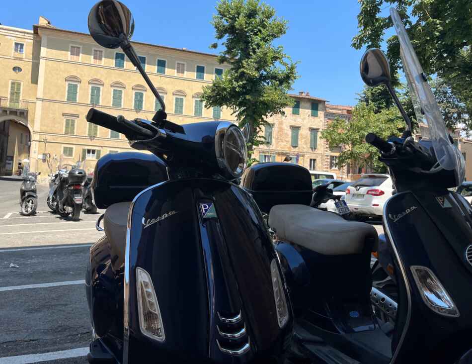 bleu vespa primavera parked in siena italy