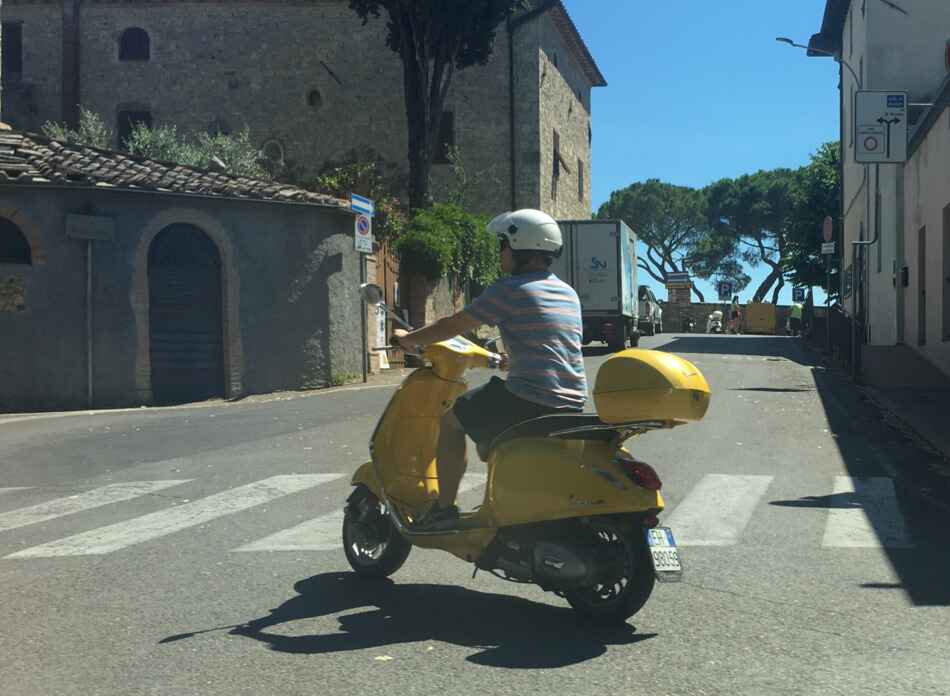 vespa driver wearing proper helmet