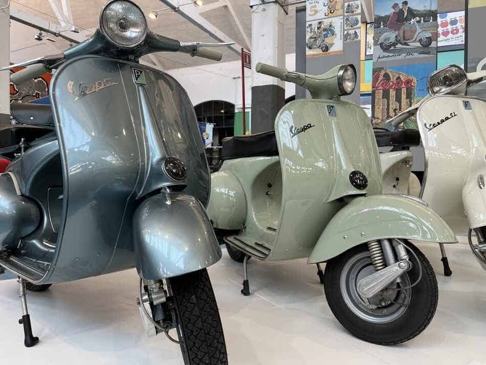 classic large frame vespas parked next to each other