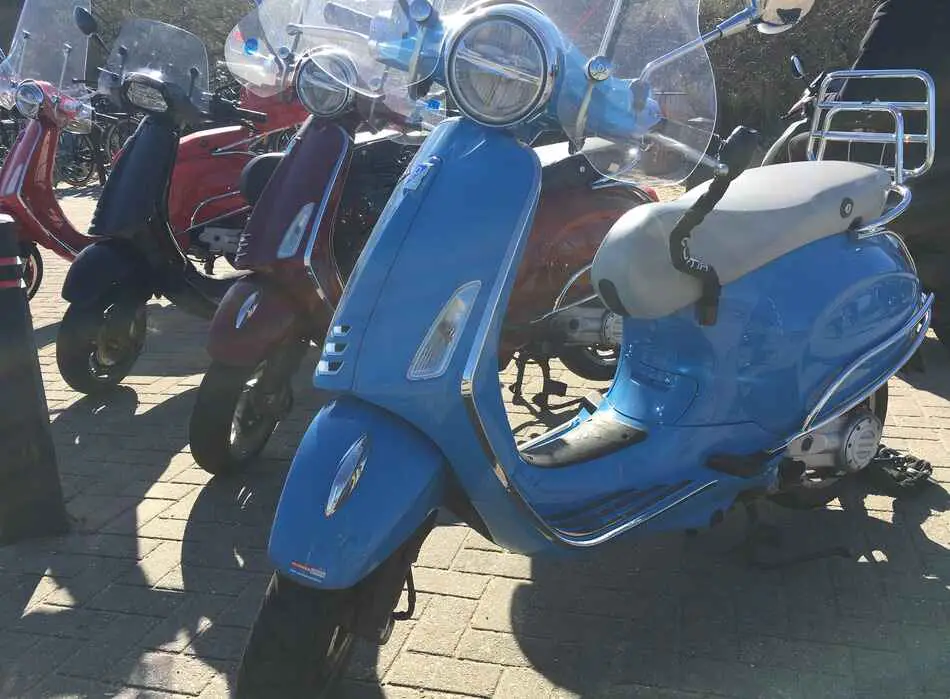 row of vespas parked next to each other